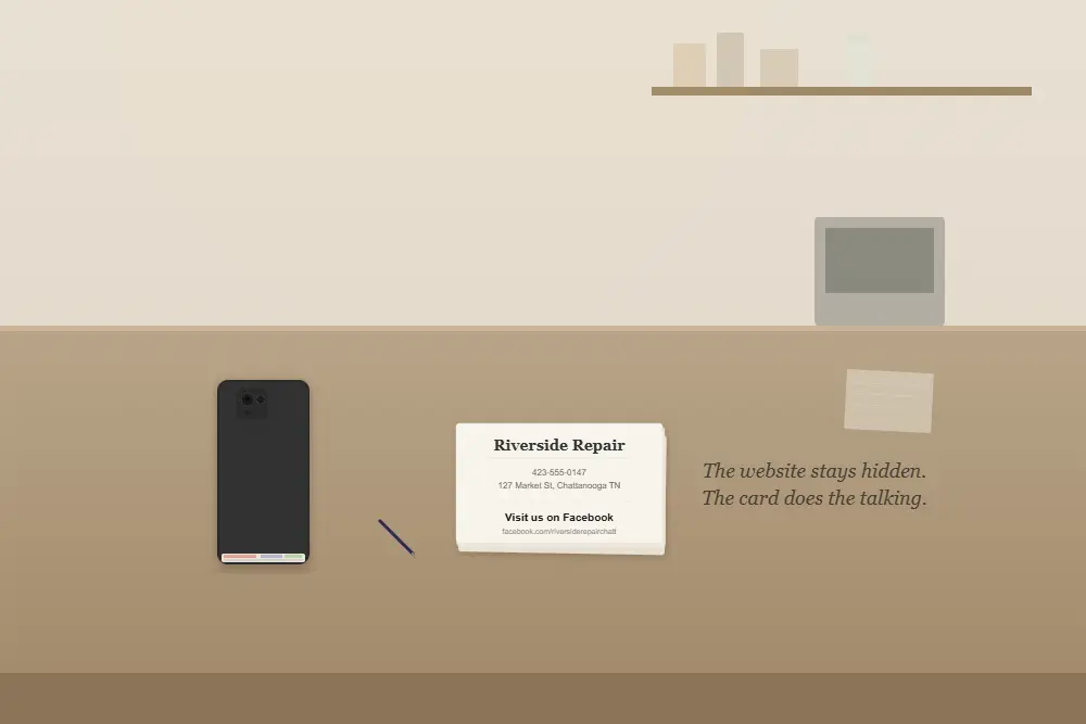 embarrassed by my website phone face-down on counter hiding dated website next to business cards